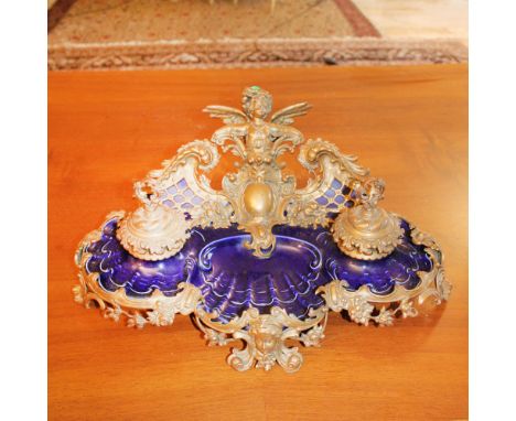 Porcelain and gilded bronze inkwell France, 19th-20th centurychiseled with plant and floral motifs, cherubs and masks20x48x32
