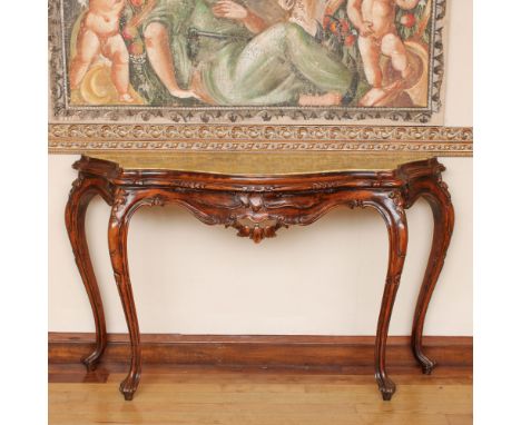 Walnut console Italy, 20th centuryshaped marble top, moved line structure carved with vegetal and volutes motifs86x145x46 cm.