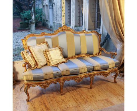 Golden wooden sofa Italy, 20th centurypartially lacquered, shaped line structure carved with scrolls and plant motifs, fabric