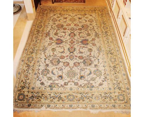 Eastern carpet 20th centurydecorated with floral and vegetal patterns on a beige background, defects and wears330x228 cm.
