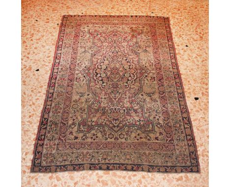 Oriental carpet 20th centurydecorated with floral and vegetable patterns on a beige and red background, wears200x125 cm.