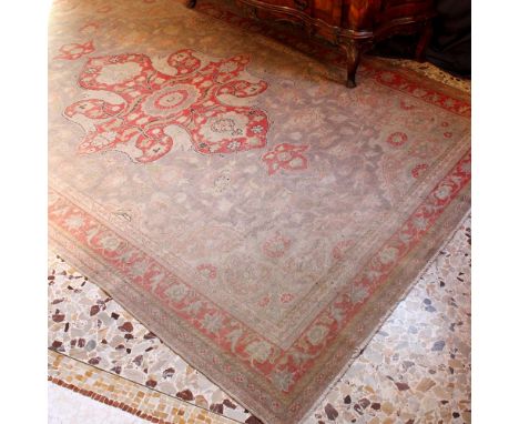 Oriental carpet 20th centurydecorated with floral and vegetal patterns on a red and beige background, wears and defects290x19
