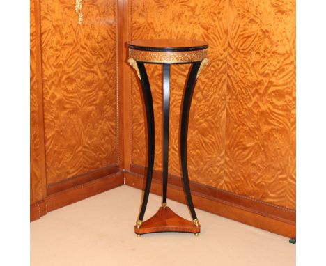 Gueridon in gilded and ebonized wood Italy, 20th centurycircular top with band below inlaid with vegetal scrolls resting on t