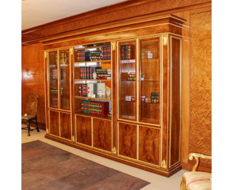 Large bookcase in walnut and golden wood Italy, 20th centurydecorated with rich applications in gilded wood and carved with p