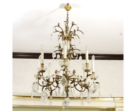 Eight lights chandelier in golden bronze Italy, 20th centuryshaped line arms with pendants and garlands in cut glass100x68 cm