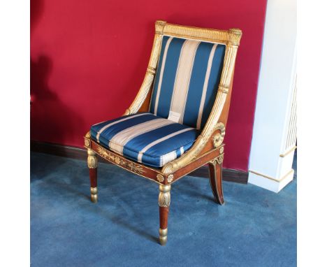 Wood and golden wood armchair Italy, 20th centurybody richly carved with vegetal volutes and Empire-style motifs, fabric upho