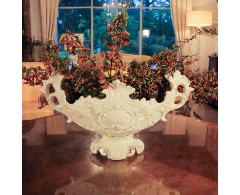 White ceramic centrepiece Italy, 20th centurydecorated with plant patterns, signed "C.Villani, Capodimonte"37x70 cm.