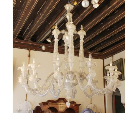 Rezzonico twelve-lights chandelier Murano, 20th centuryin transparent glass, wavy arms with rich decorations of leaves and fi