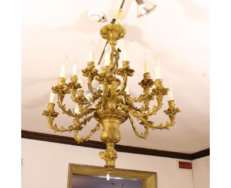 Sixteen lights bronze chandelier Italy, 20th centurychiseled with vegetal and floral motifs, branched arms95x85 cm.