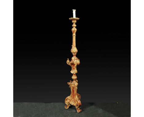 Electrified torchholder Venice, 18th century.in lacquered and golden wood, carved with vegetal motifs and opposite volutes, r