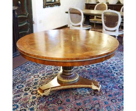 Centerpiece table in walnut Italy, 20th centurycircular top inlaid with plant motifs resting on a wooden support carved with 