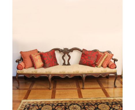 Walnut sofa Italy, XVIII century.structure carved and pierced with motifs of vegetal volutes, moved line armrests, fabric uph