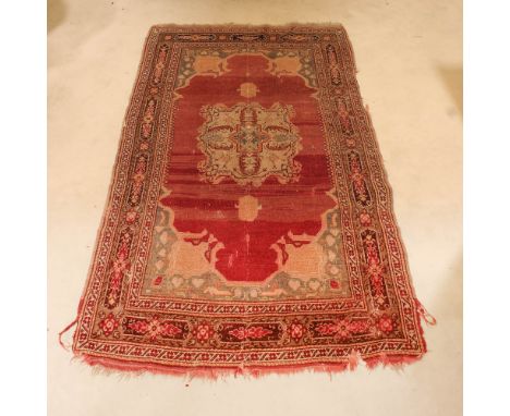 Oriental carpet 20th centurydecorated with vegetal and floral patterns on a red background, defects and shortcomings205x112 c