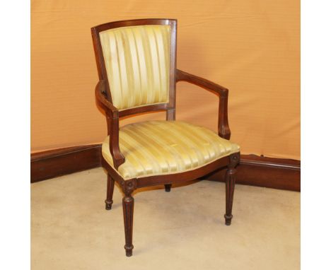 Walnut armchair Italy, 20th centuryshaped structure resting on grooved legs, fabric upholstered and covered seat and backrest