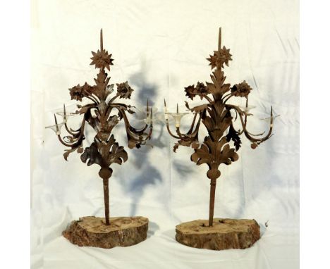 Pair of four-armed wrought iron candlesticks Italy, 19th-20th centuryand forged with plant motifs, resting on wooden bases, d