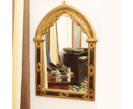 Golden and lacquered wooden mirror Italy, 20th centuryGothic line structure, carved with geometric and plant motifs104x69 cm.