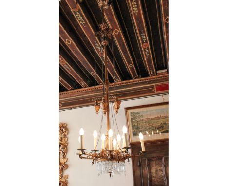 Golden bronze chandelier XIX-XX sec.chiseled with masks and vegetable motifs, cup and pendants in cut glass190x70 cm.
