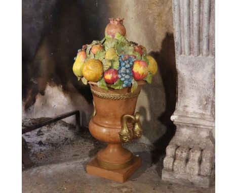 Terracotta vase Italy, 20th centurypartially gilded and decorated with a triumph of fruit80x40 cm.