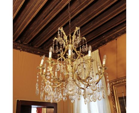Golden bronze ten lights chandelier Italy, 20th centurystructure decorated with plant motifs, moved arms with cut glass penda