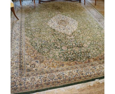 Oriental carpet 20th centurydecorated with floral and plant patterns on a green and beige background, defects370x275 cm.
