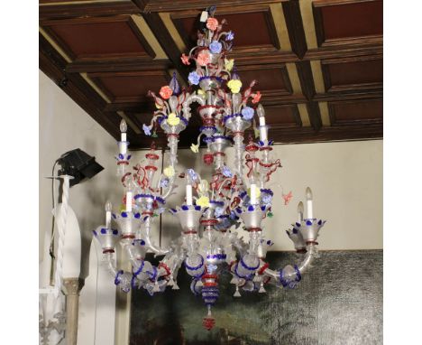 Rezzonico twelve-lights chandelier Murano, 20th centuryin transparent and colorful glass, moved arms with rich decorations of