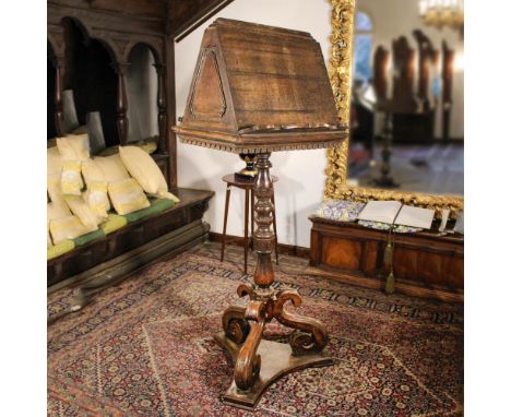 Walnut lectern Italy, 19th centuryresting on a turned support with tripod terminals172x69x58 cm.
