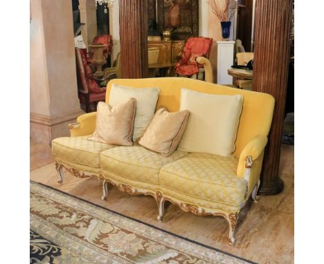 A sofa and two armchairs Italy, 20th centuryin white lacquered and partially gilded wood, fabric upholstered and covered seat