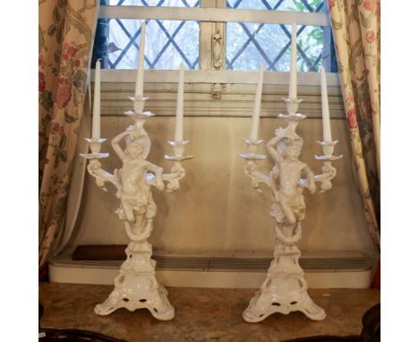 Pair of three lights candlesticks in white ceramic Nove, Bassano 20th centurydecorated with male figures and rich plant motif