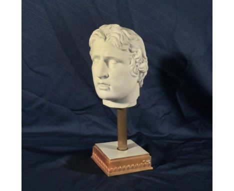 Biscuit head 20th centurydepicting a male face, resting on a gilded porcelain base decorated with Empire style motifs, signed