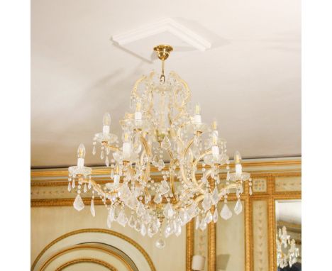 Twelve-lights chandelier in glass and brass Italy, 20th centurydecorated with glass garlands and pendants93x80 cm.