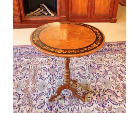 Walnut coffee table Italy, 19th centurycircular top inlaid with geometric elements and floral motifs resting on a turned supp