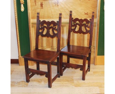 Pair of walnut-stained wooden chairs Italy, 20th centuryperforated backrests with plant motifs, wooden seats107x47x40 cm.