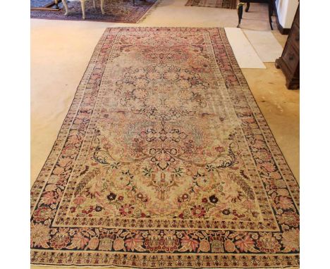 Oriental carpet 20th centurydecorated with floral and vegetal patterns on a beige background, wears and defects365x164 cm.
