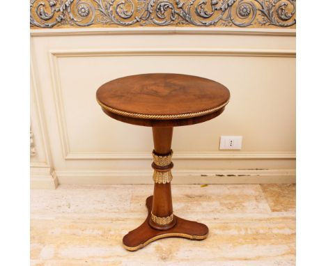 Walnut coffee table Italy, 20th centurycircular top resting on a turned support with tripod terminal, decorated with gilded w