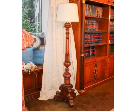 Walnut floor lamp Italy, 20th centuryturned and fluted body resting on a tripod base, complete with lampshade195x50 cm.