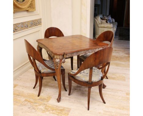 Walnut game table Italy, 20th centuryshaped top, underlying band decorated with partially silvered plant elements, wavy legs,