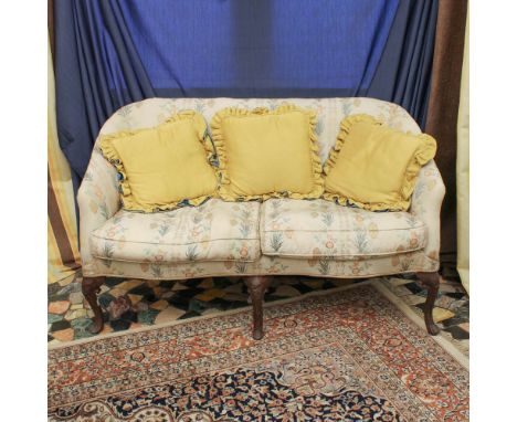 Two-seater sofa Italy, 19th centuryPadded structure covered in fabric, resting on shaped walnut legs, defects85x145x70 cm.