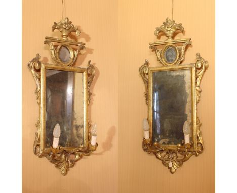 Pair of gilded wooden mirrors Italy, XVIII century.rectangular frame decorated with floral and plant motifs, complete with tw