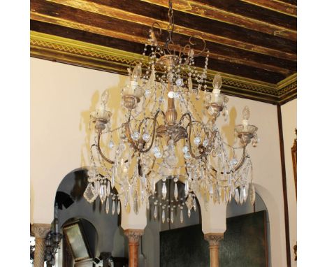 Six-light chandelier in wood and golden iron Italy, 20th centuryCarved and podded wooden structure, shaped iron arms gathered