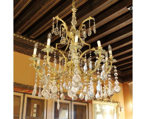 Golden bronze ten lights chandelier Italy, 20th centuryStructure decorated with plant motifs, moved arms with cut glass penda