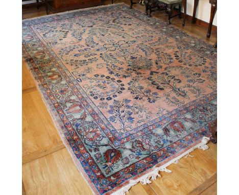 Oriental carpet 20th centurydecorated with plant and floral motifs on a pink and light blue background, slight defects385x263