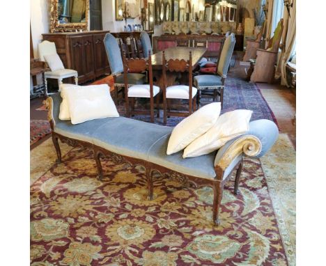 Three-seater walnut bench Italy, 18th centurystructure carved with plant and scroll motifs, shaped armrests in gilded wood, p