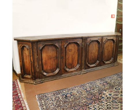 Large walnut rounded sideboard Italy, 18th centuryShaped top with six doors underneath, defects110x335x51 cm.