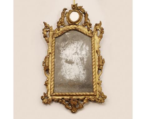 Gilded wooden mirror Italy, XVIII century.shaped frame carved with vegetal motifs and architectural elements73x39 cm.