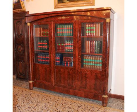 Mahogany feather bookcase France, 19th centuryfront with three doors delimited by columns with golden and chiseled bronze bas
