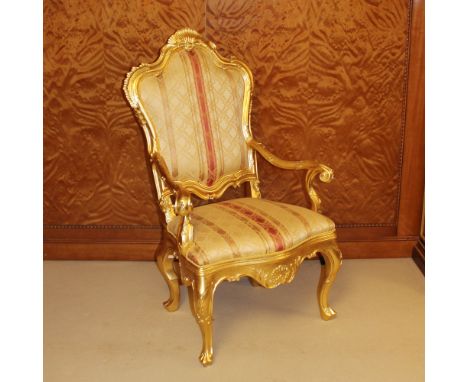 Gilded wood armchair Italy, 20th centurycarved structure with plant and scroll motifs, fabric upholstered and covered seat an