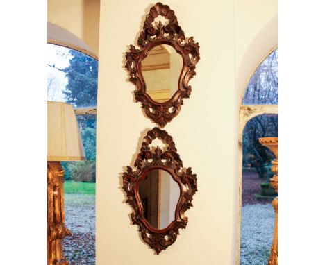 Pair of carved wooden mirrors Italy, 19th centurywith plant and scroll-shaped motifs68x42 cm.