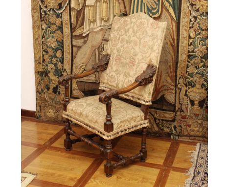 Walnut armchair Italy, XVIII century.turned structure with moved line armrests carved with vegetal motifs, fabric upholstered