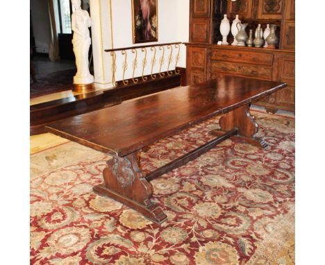 Walnut refectory table Italy, 20th centuryrectangular top resting on shaped bases joined at the center by a cross and decorat