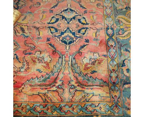 Oriental carpet 20th centurydecorated with vegetal and floral patterns on orange and blue background, defects430x300 cm.